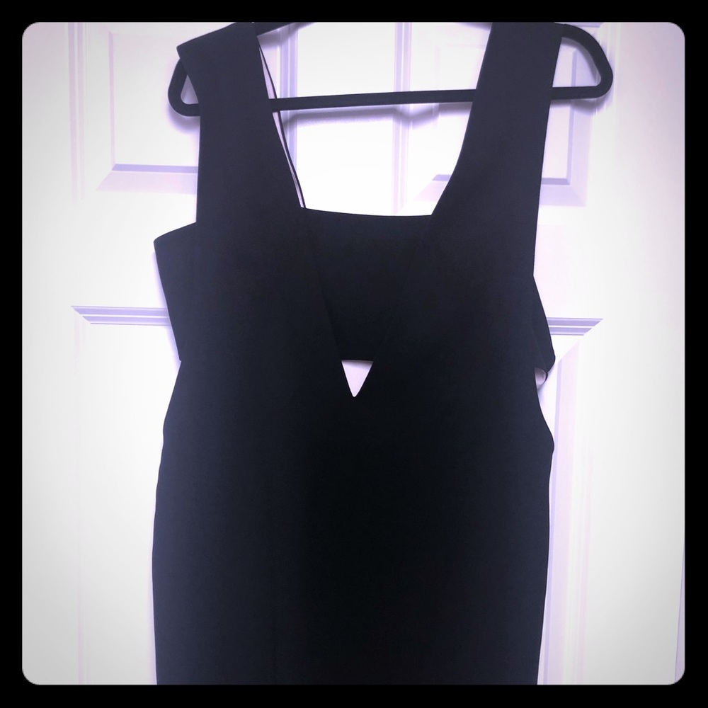 Black cocktail dress with cutout sides.